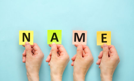NAME word written on color paper cards NAME text on blue table for your desing, concept.の写真素材