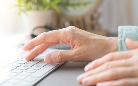 Female office worker typing on the keyboard. Business Concept.