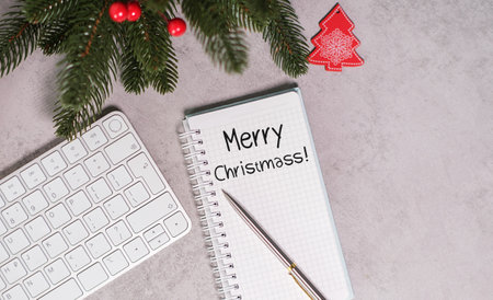 Merry Christmas! - Note Pad With Text On Gray Table