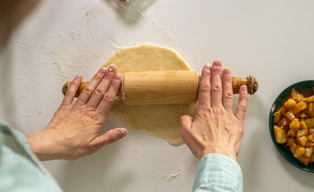 Making American pie rolling out dough hands close up, Close up of Hands Handling Food