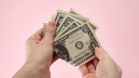 grab one dollar bill, get tip, small pocket money or donation with copy-space at the right sideの写真素材