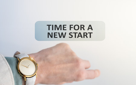 Wristwatch on a woman's hand, time does not matter, girl with a watch and the inscription Time For a New Startの写真素材