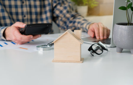 Close-up of a judge's hammer small wooden toy house On the table in the courtroom concept of real estate law division of property Land separation and divorceの写真素材