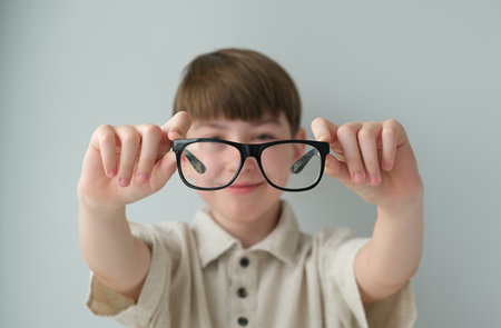 Banner little boy with glasses correcting myopia close-up portrait Ophthalmology problem selective focusの写真素材