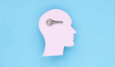 The concept of unlocking your potential. Figurine of a man's head with a key, concept for the...