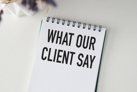 Notebook with text WHAT OUR CLIENTS SAY . Diagram and white background,Businessの写真素材