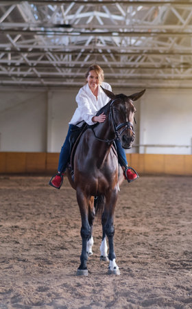 Woman riding horse dramatic sky, Mature woman hugging horseの写真素材