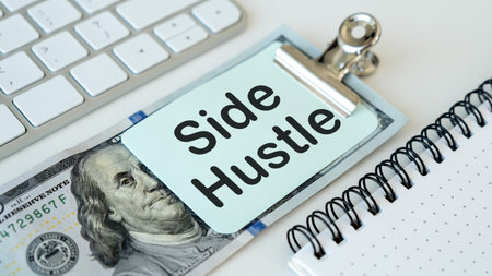 The stack of money is marked with side Hustle. Additional income and entrepreneurial enterprises.の写真素材