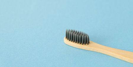 Organic bamboo toothbrush on blue background. Eco friendly. Free copy space