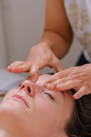 Young woman relaxing during back massage at the spa.の写真素材
