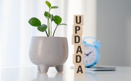 The words update is standing on wooden cubes, progress in business, desk in and officeの写真素材