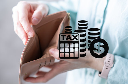 Close-up of woman's hands with empty wallet and utility bills. The concept of rising prices for...