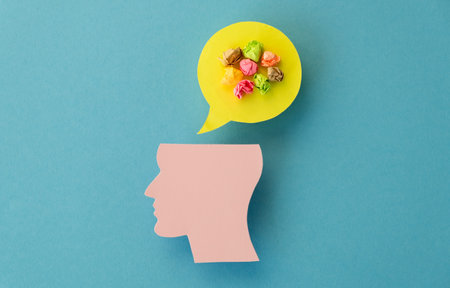 World mental health day concept. Paper human head symbol and crumpled colored papers on blue backgroundの写真素材