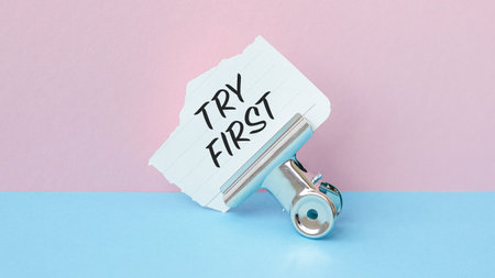 Try First text on torn paper pink backgroundの写真素材