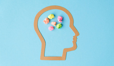 A head with a bunch of crumpled paper in the shape of a brain. The crumpled paper represents the brain's ability to think and process informationの写真素材