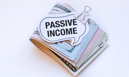 A stack of money with a sign that says Passive Income on top. Concept of making money without actively working for itの写真素材