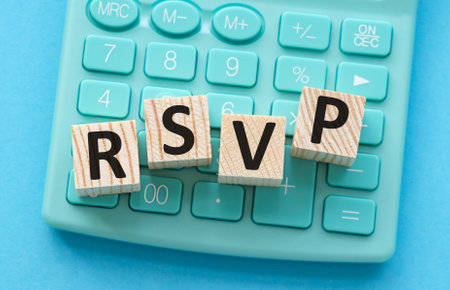 A calculator with the letters RSVP written on it. Concept of playfulness and creativity, as the letters are arranged in a way that resembles a puzzle or a gameの写真素材