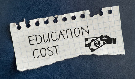 A piece of paper with the word education cost written on it. The paper is torn and crumpled, and it is a makeshift signの写真素材
