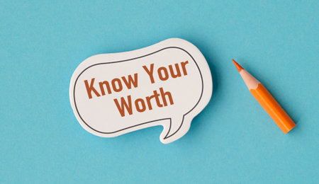 A white sticker with the word Know Your Worth written on it. A pencil is next to the stickerの写真素材