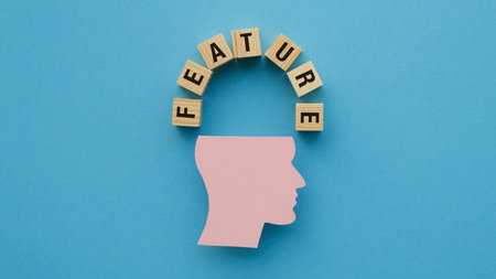 A head with the letters feature written around it. The head is pink and the letters are woodenの写真素材