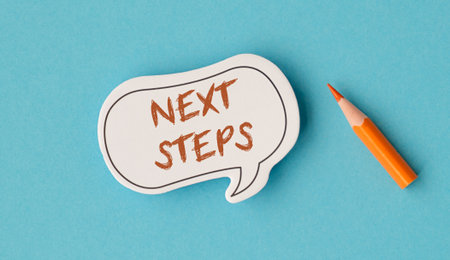 A white paper with a speech bubble that says Next Steps and a pencil next to itの写真素材