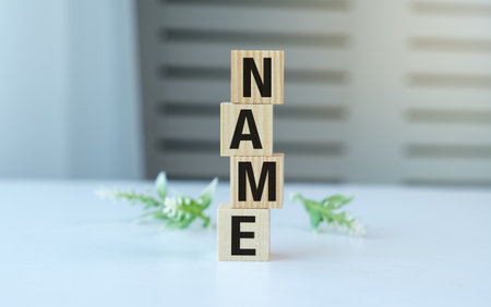 A stack of wooden blocks with the letters Name on top. The blocks are arranged in a way that spells out the nameの写真素材