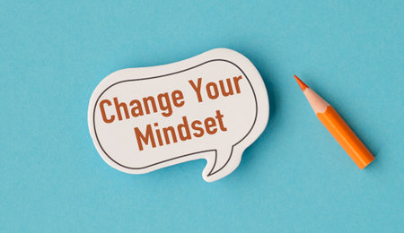 A white sticker with the words Change Your Mindset written on it. A pencil is next to the stickerの写真素材