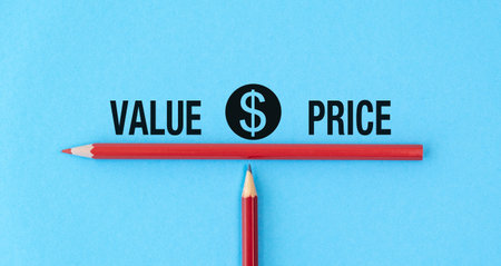 A red pencil is on a blue background with the words Value Price written below it. A second red pencil is on the right side of the first pencilの写真素材