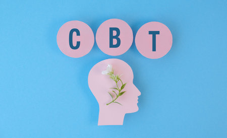 A head with a flower on it and the letters CBT. The letters are pink and blueの写真素材