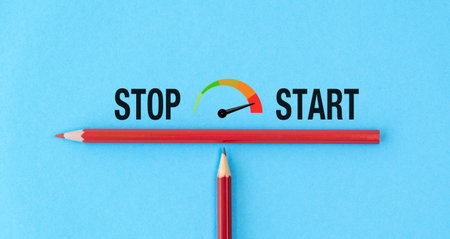 A red pencil is placed next to a green pencil. The green pencil is positioned on top of the red pencil, creating a visually appealing contrast between the two colorsの写真素材