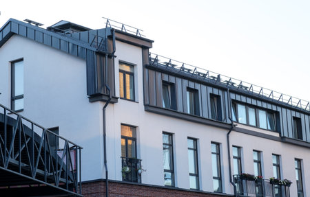 A building with a balcony and a roof. The balcony is on the left side of the buildingの写真素材
