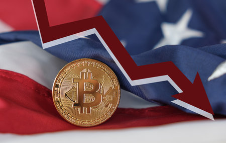 A coin with the letter B on it is on a red, white, and blue flag. The flag is on a tableの写真素材