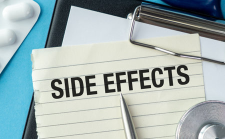A piece of paper with the word Side Effects written on it. A pen is sitting on top of the paper