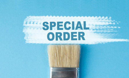 A paintbrush with the word Special Order written on it. The brush is white and the background is...