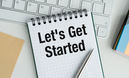 A notebook with the words Let's Get Started written on it. A pen is sitting on top of the notebookの写真素材