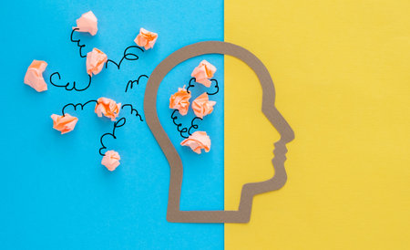 A head with a bunch of paper on it. The paper is crumpled and scattered all over the head. The head...