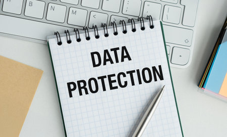 A notebook with the word Data Protection written on it. A pen is sitting on top of the notebookの写真素材