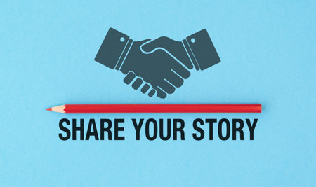 A pencil is placed next to a handshake symbol, with the words Share Your Story written below