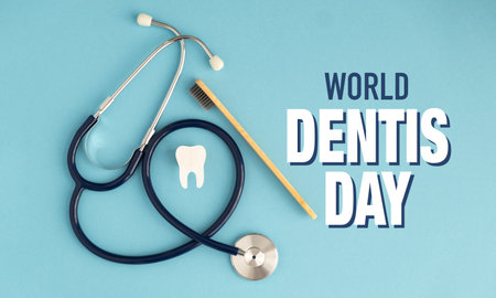 A stethoscope, toothbrush and toothpaste are on a blue background. The image is titled World Dentists Dayの写真素材
