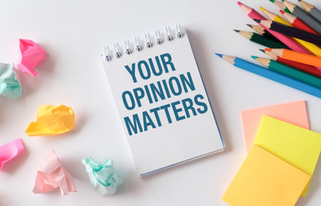Your Opinion Matters symbol. Concept words Your opinion matters on beautiful white notebook. White background. Businessman hand. Business your opinion matters concept.の写真素材