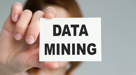 A person is holding a white card that says Data Mining. The person is holding the card up to the camera, and the image conveys a sense of importance and focus on the topic of data miningの写真素材