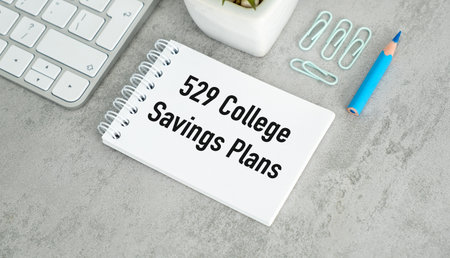 A white spiral notebook with the number 529 on it. The notebook is on a desk with a pencil and a...