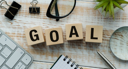 Wooden block with the word Goal carved on birch cubes highlighting personal aspirationsの写真素材