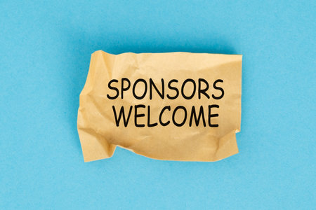 Sponsors Welcome concept. The message Sponsors Welcome on a sticky note paper on blue backgroundの写真素材
