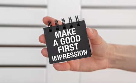 Hand holding a card with text Make a good first impression, Business Conceptの写真素材
