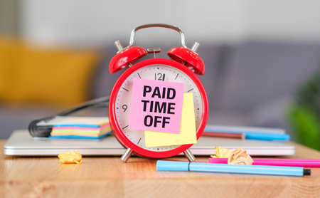 Paid Time Off Reminder: A Conceptual Image Featuring an Red Alarm Clock and a Noteの写真素材