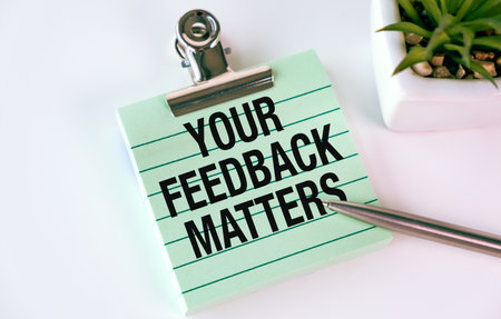 Your Feedback Matters on paper against White background. Symbolic feedback concept. Space for copy.