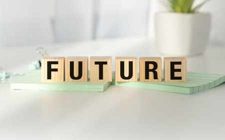 A wooden block with the word FUTURE written on it. The blocks are arranged in a way that creates a sense of progression and growth, suggesting that the future is something to look forward toの写真素材
