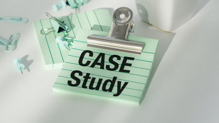 A Case Study is written on a green piece of paper. The paper is sitting on a table with a pair of...