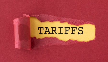 A torn piece of paper with the words Tariffs written on it. The image has a mood of simplicity and...